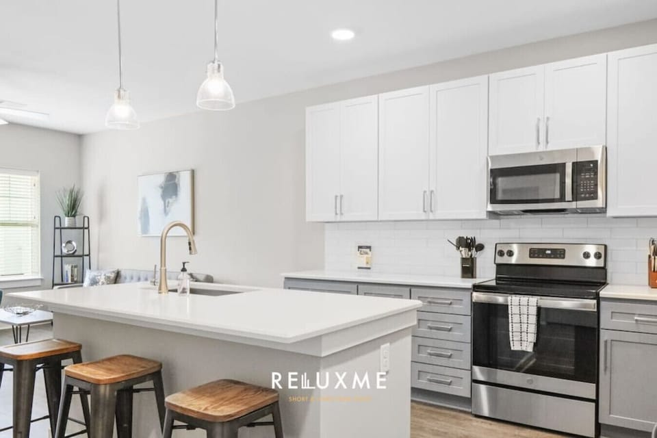 Modern kitchen equipped with cookware, pots & pans, utensils, coffee machine