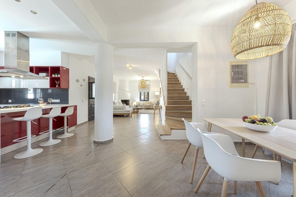 Dinner area, kitchen island and staircase to the upper level