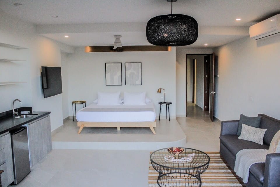 One of two master suites with private balcony overlooking pool below and beach