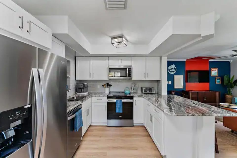 Stainless steel appliances | Kitchen island | Cooking utensils and cutlery 