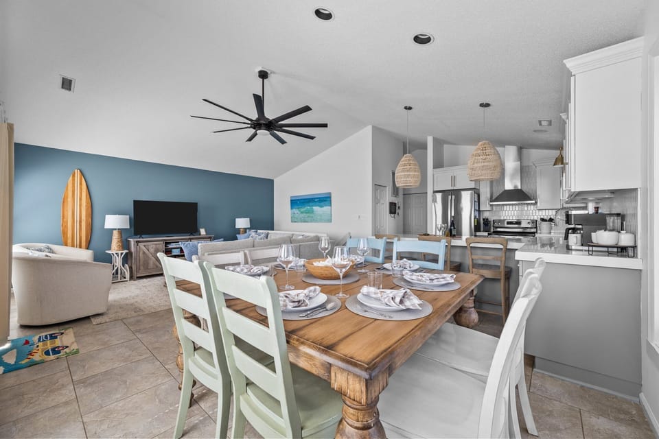 A side dining table seats eight, plus seating for three more at the adjacent peninsula.