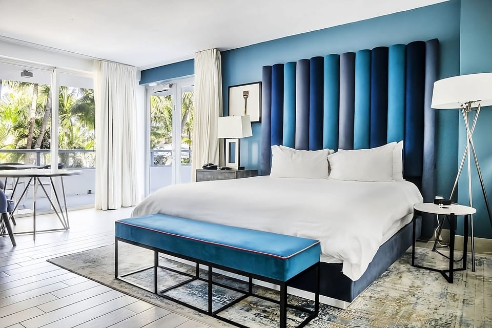 Wake up to palm views from this serene designer bedroom.