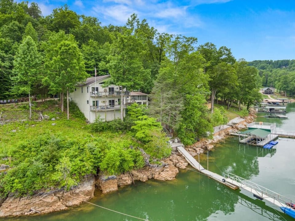 The house nestled in the privacy of approximately 2 wooded lakefront acres