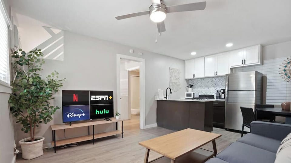 Living room with sleeper sofa, smart tv, full kitchen, and dining