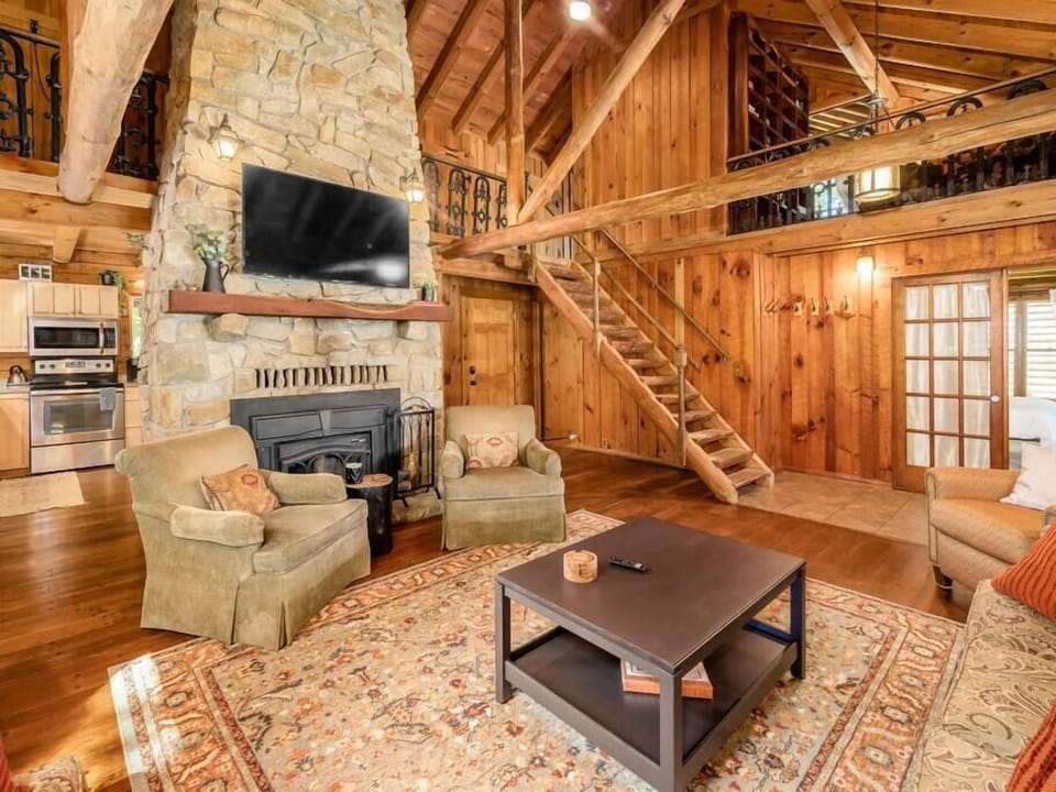 Cozy ambiance around the stunning stone fireplace in the living room.