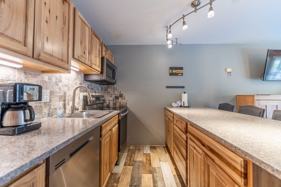 Full-sized kitchen with upgraded, stainless steel appliances.