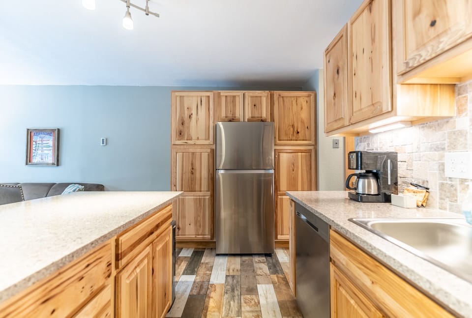 Full-sized kitchen with upgraded, stainless steel appliances.