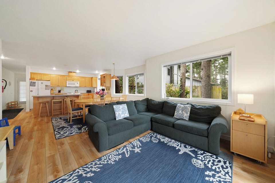 Picture yourself unwinding on the plush sectional, natural light pouring through large windows, and the open kitchen inviting you to whip up meals with ease.