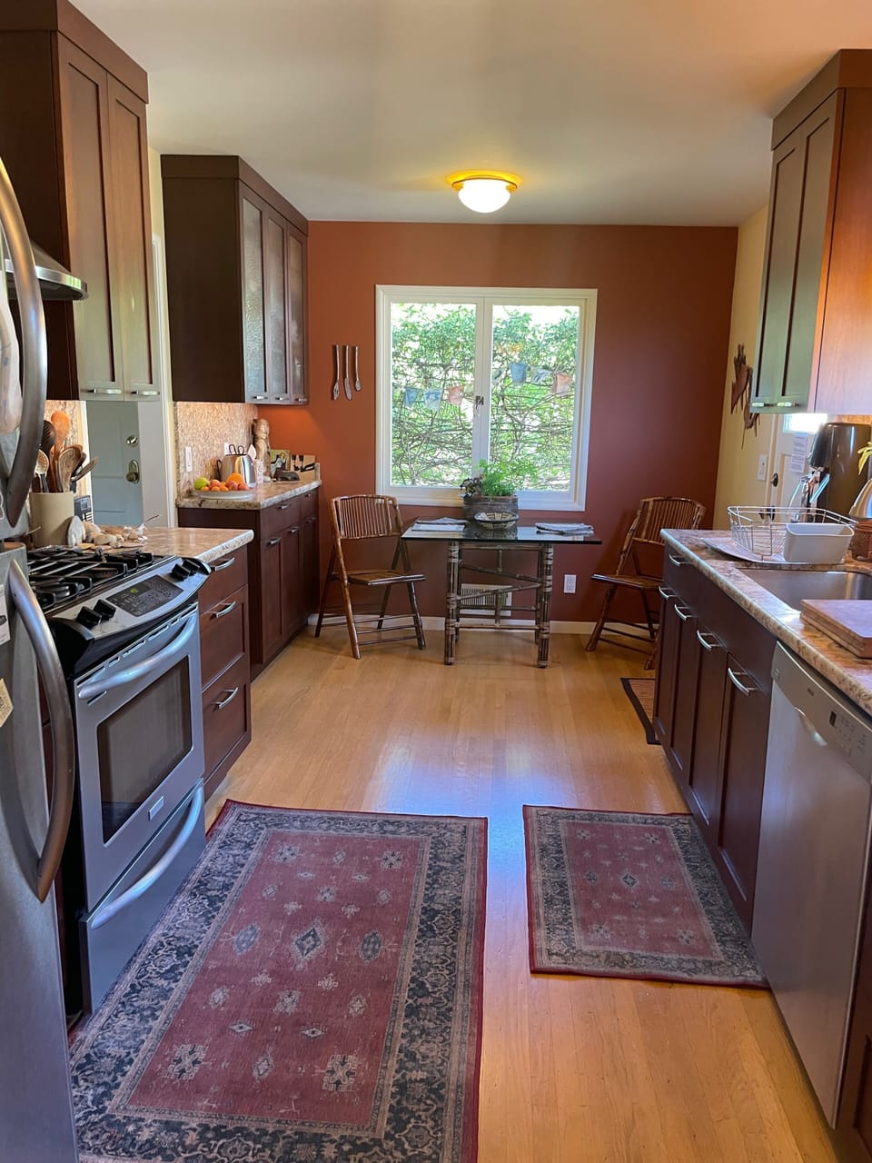 There's a lovely table by the front window, made private by variegated vines.