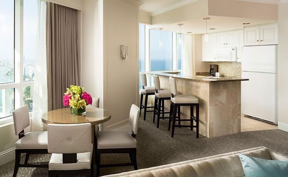 Enjoy breezy breakfasts with a kitchenette and ocean beyond.
