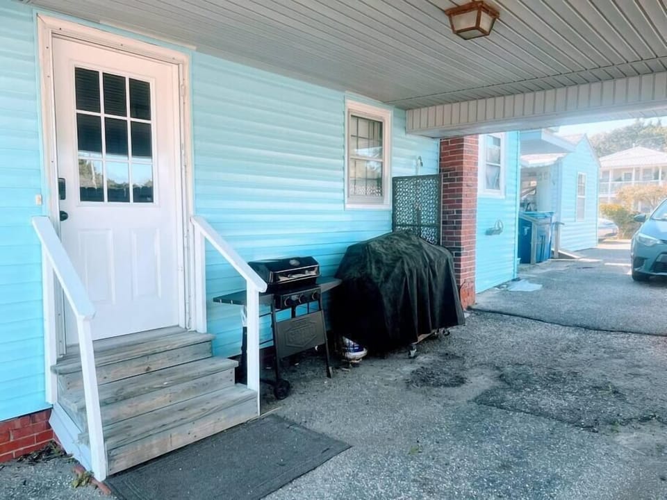 Entry door under covered carport -- charcoal and gas grills and private outdoor shower
