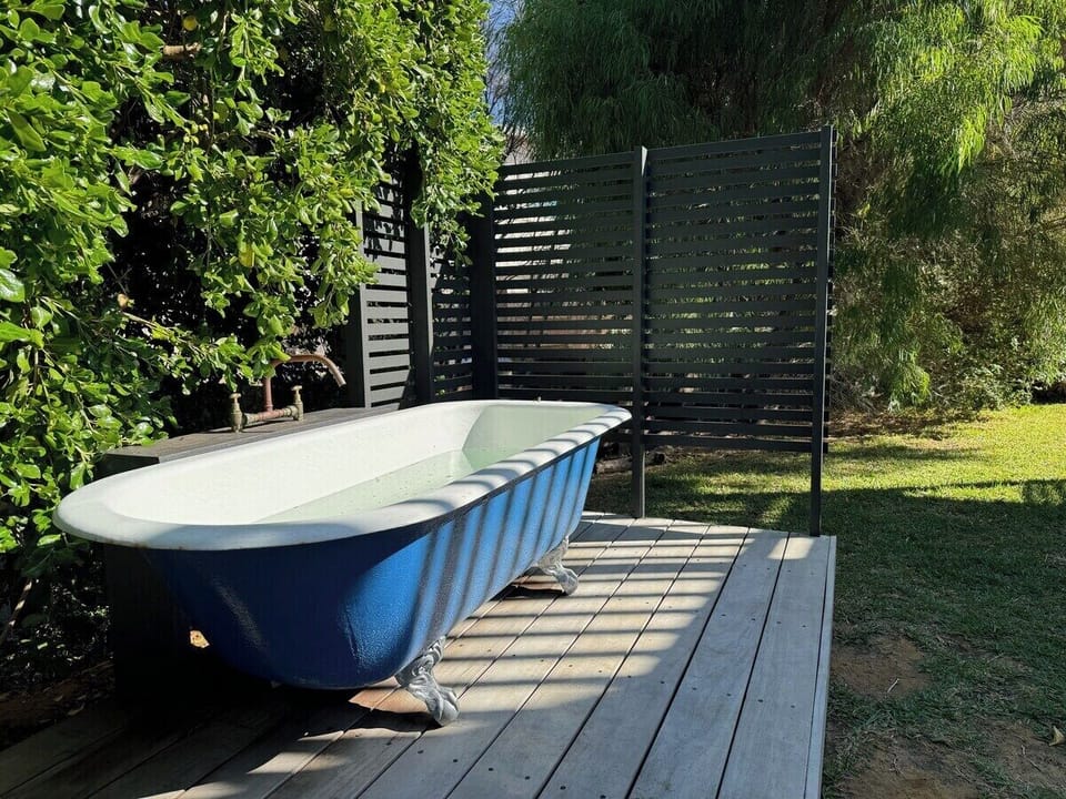 Soak beneath the open sky in the unique outdoor bath, a memorable way to unwind after the beach.