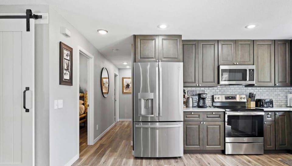 Well equipped kitchen with ample dishes, pots and pans,  and small appliances to cook meals at home