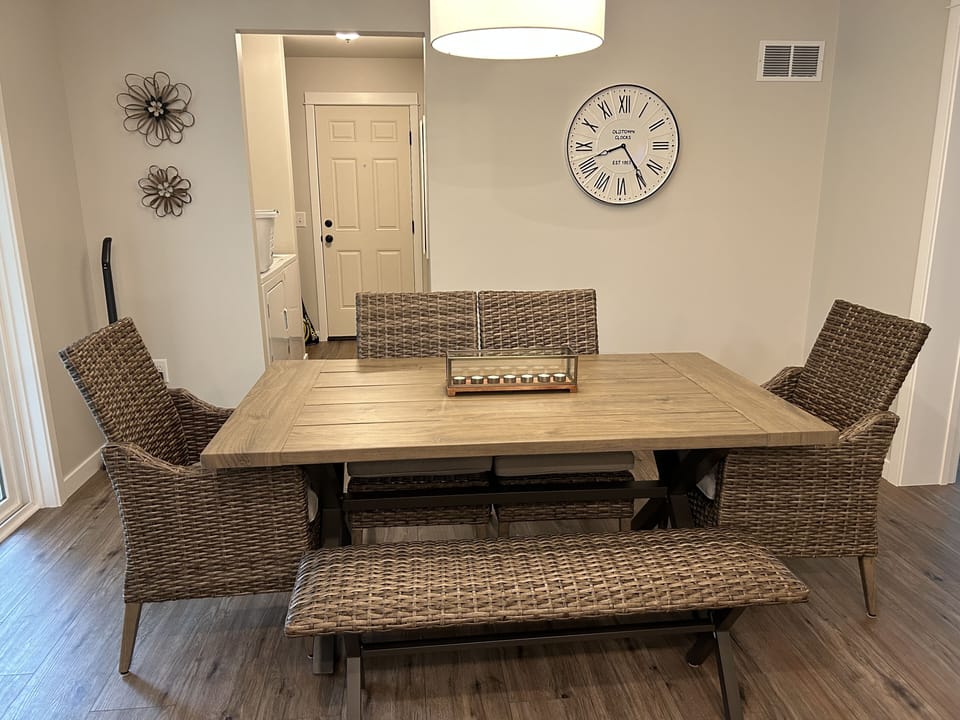 Dining area with hallway to side door, washer/dryer and additional amenities. 