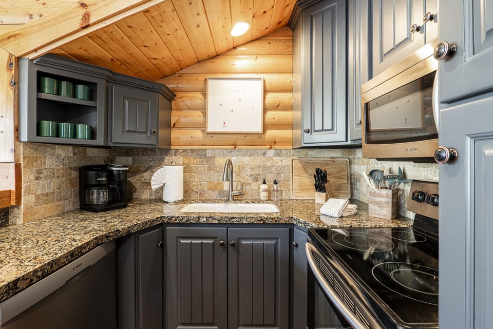 Fully Equipped Kitchen with Stone Counters and Stainless Steel Appliance