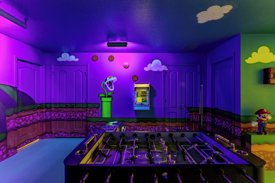 Level Up! Our custom Super Nintendo room is pure fun! Enjoy the indoor slide, 2 arcades, pool, foosball, and air hockey. Don't miss the black light show where the hand-painted murals glow spectacularly! Nonstop family entertainment guaranteed.