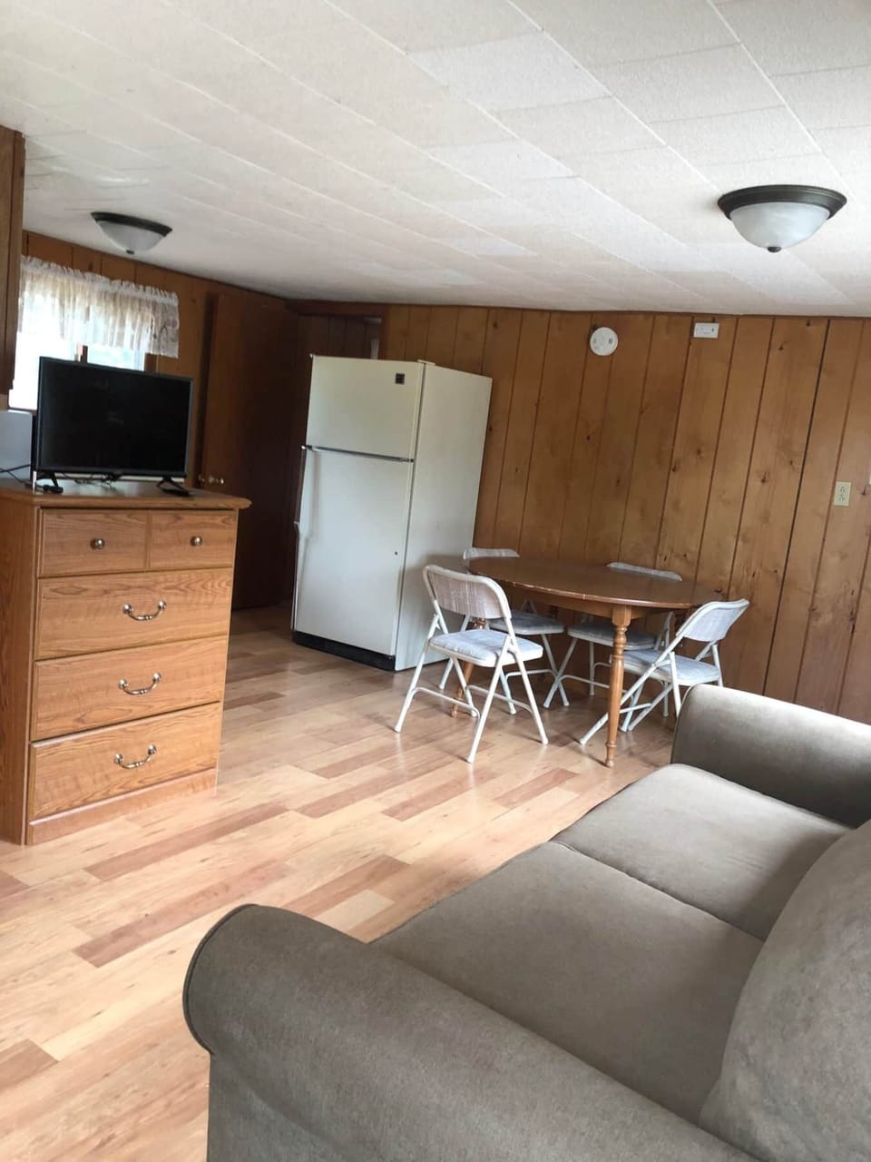 Living Area features a smart tv and full size dresser