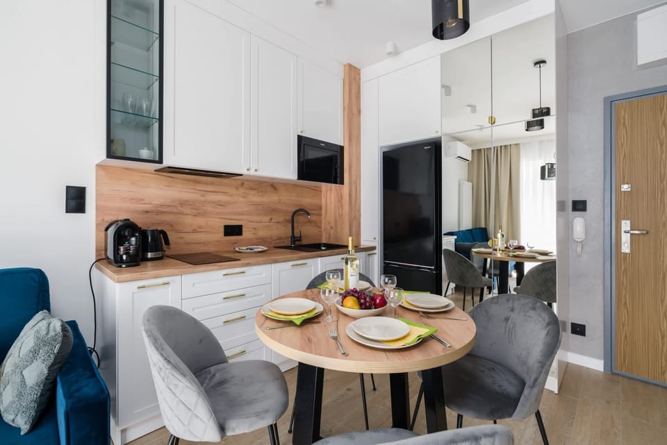 The spacious living room features a sofa bed and a flat-screen television.