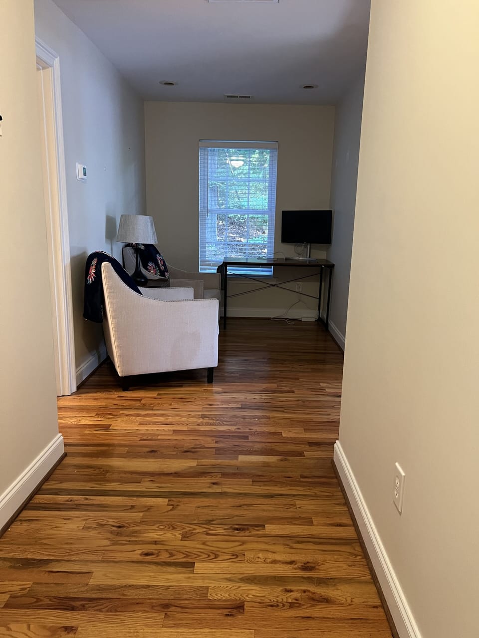 Upstairs open area with seating and desk with monitor/printer 
