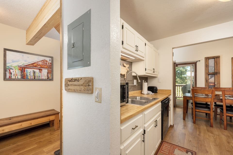 Your fully equipped galley kitchen features butcher block counters, white cabinetry, and everything you need to prepare meals during your mountain getaway.