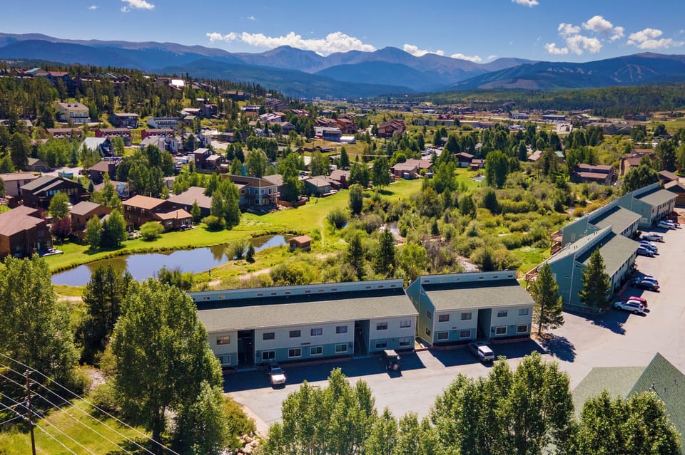 Stunning aerial view of the property nestled in a picturesque mountain valley, surrounded by pristine natural beauty and charming neighborhood.