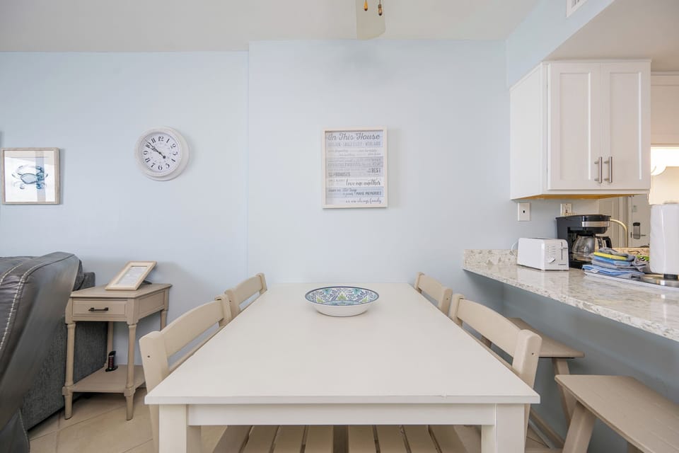 Gather around the cozy dining table for family game nights or casual chats, surrounded by uplifting decor