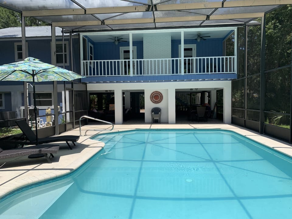 Pool area fully equipped with two tables, chairs, towels and Cabana,