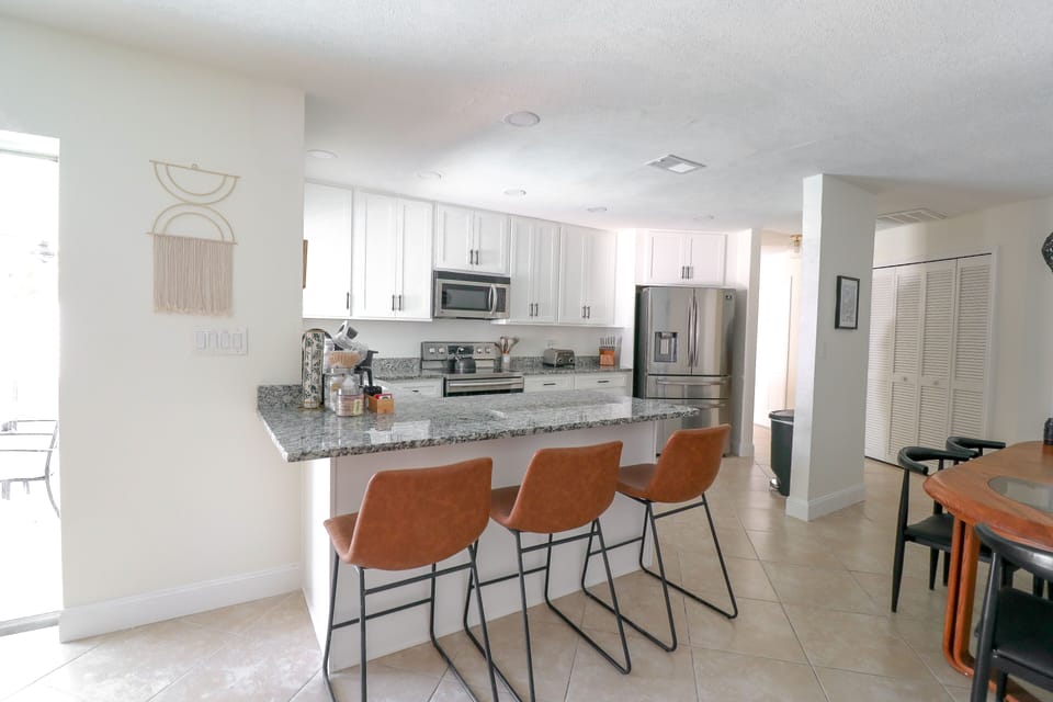 View from the living room, sliding glass doors out to lanai next to the kitchen.