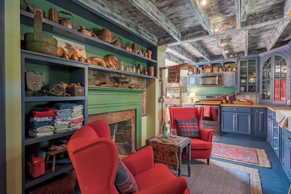The kitchen is full of character (and full of cookware) with a unique blend of cabinets. Who are the lucky ones that get to relax and watch the chef?? 
