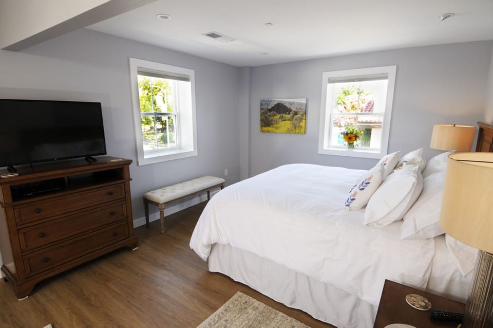 View from queen size bed of the king size bed and windows that face the plaza.