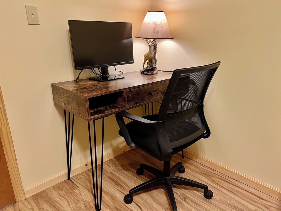Private workspace in downstairs bedroom with included external monitor