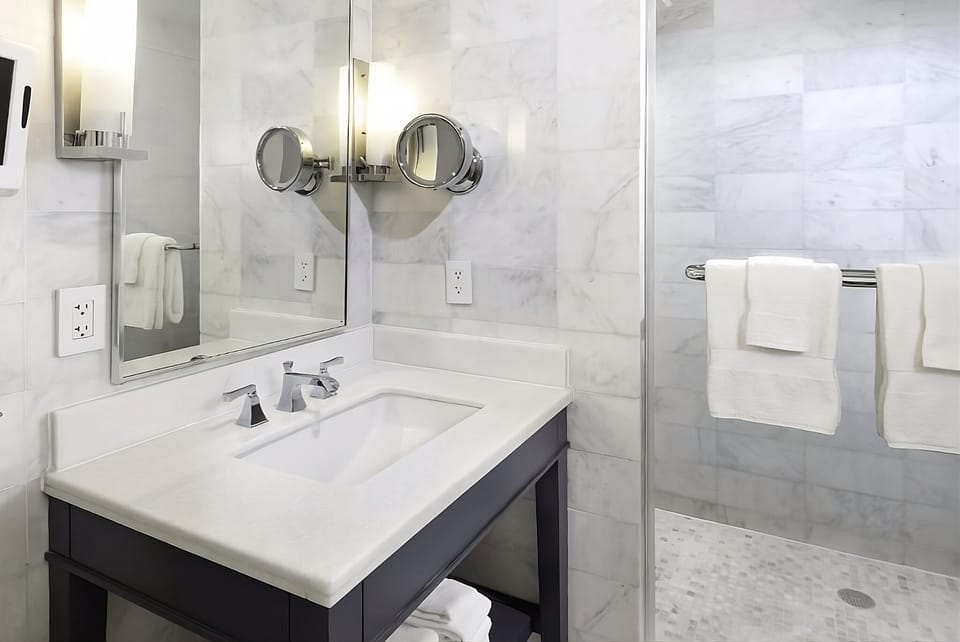 Freshen up in a sleek marble bathroom with spa-like finishes
