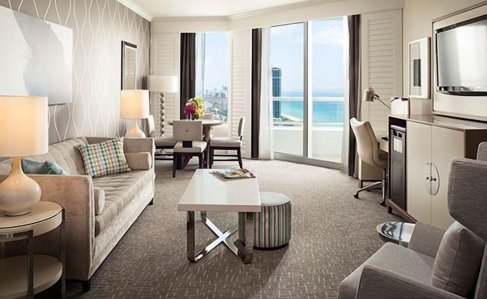 Lounge in style with sunlight pouring through balcony doors.