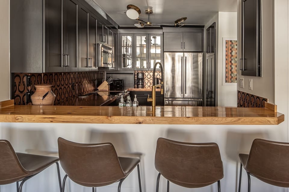 Your modern kitchen invites culinary adventures with sleek cabinetry, gleaming countertops, and professional appliances that make every meal special.