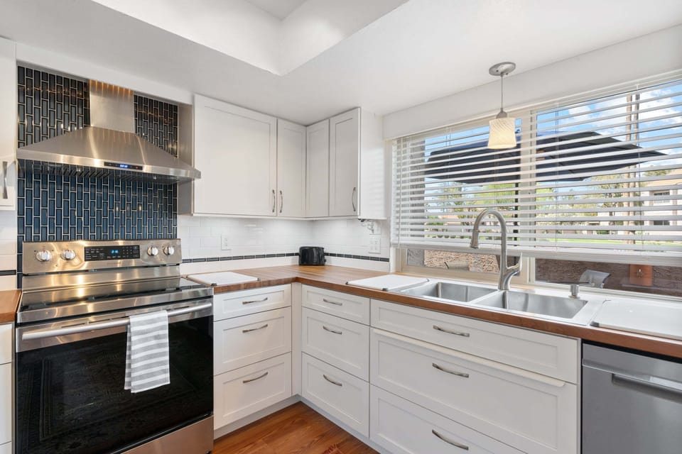 The window above the kitchen sink provides the space with ample bright light and a view to the world.