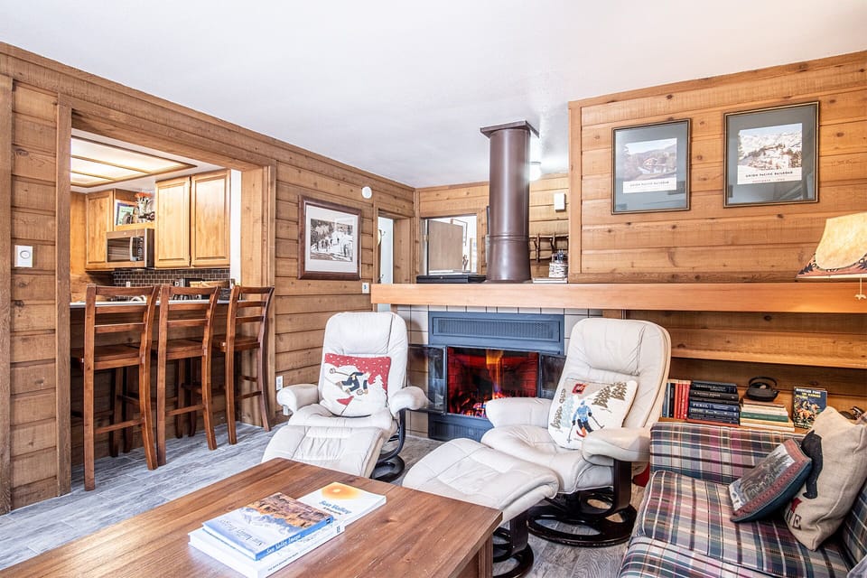 he living room features a wood burning fireplace