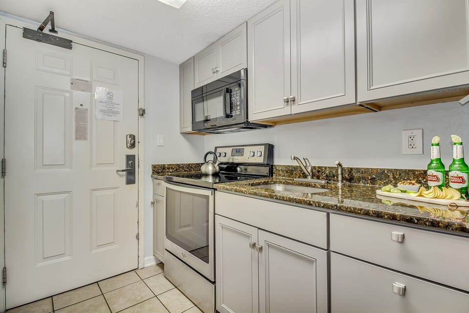 Step into our suite's kitchen, a gourmet haven equipped with modern appliances, sleek countertops, and everything you need to whip up a culinary masterpiece!