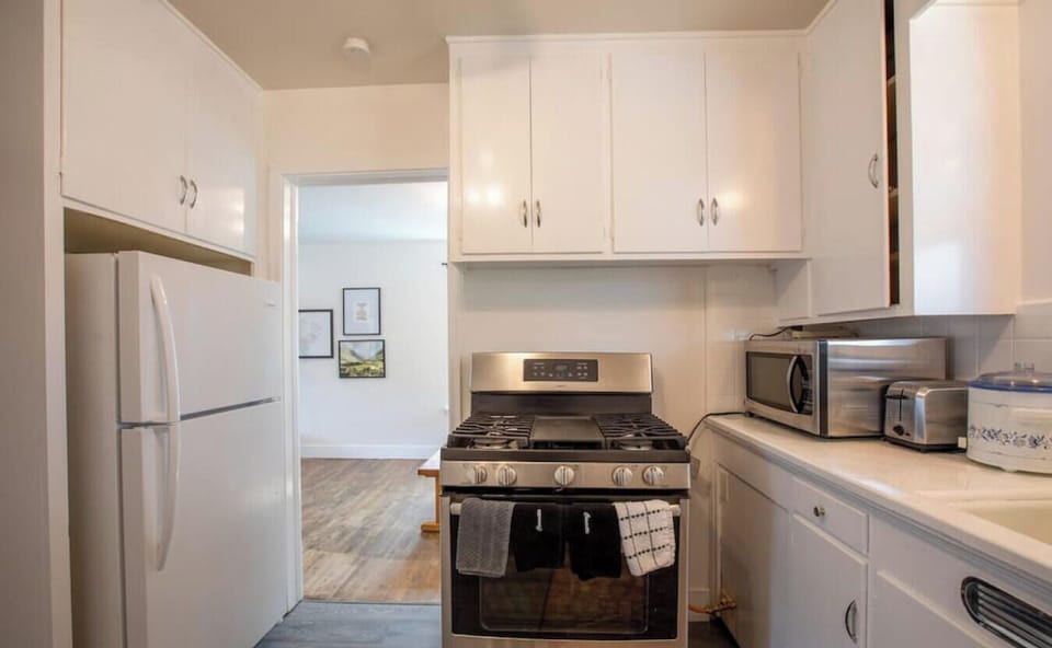 Kitchen with stove, fridge, and storage