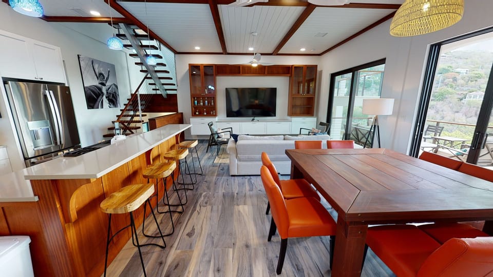 Living room with 8 place dining table and entertainment center 
