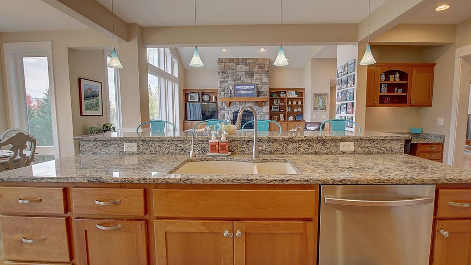 Kitchen island with breakfast bar overlooks the living room and breakfast nook