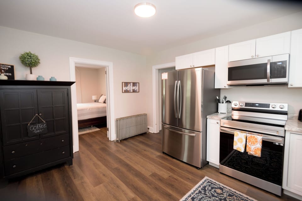 First floor kitchen, fully stocked. Bedroom with queen bed off the bedroom 