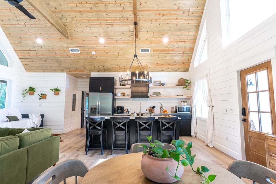The kitchen features a large island with additional seating.