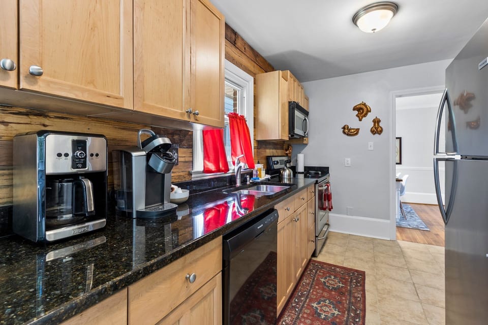 Full Kitchen with oven, dishwasher, refrigerator, microwave, and coffee maker.