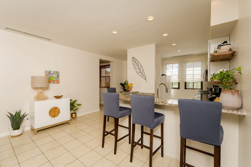 Bright open concept kitchen overlooking manicured grounds.