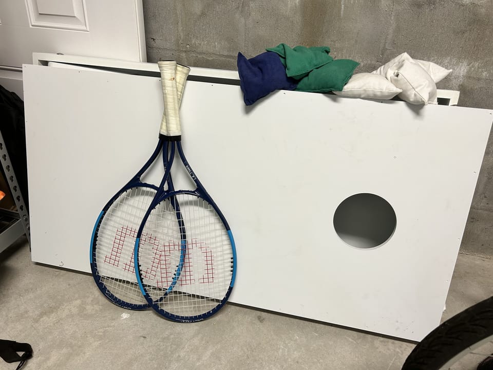 Corn hole and tennis rackets 
