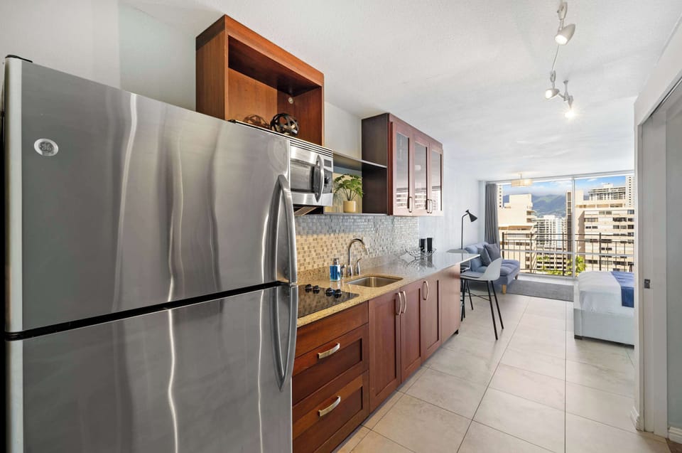 Another angle of the kitchen and a bed
