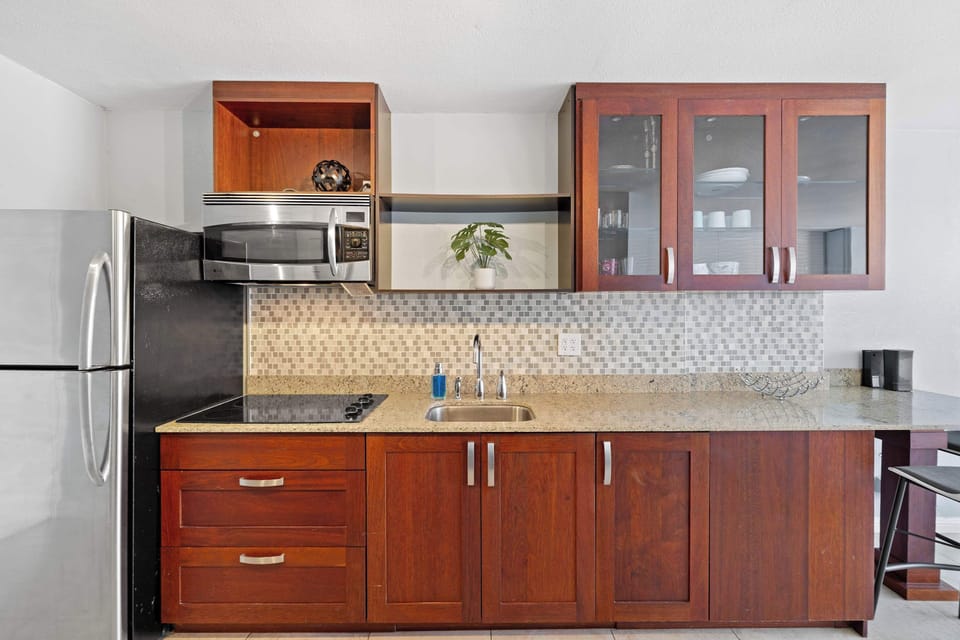 Modern kitchen with basic appliances, sleek counters, and stylish cabinetry