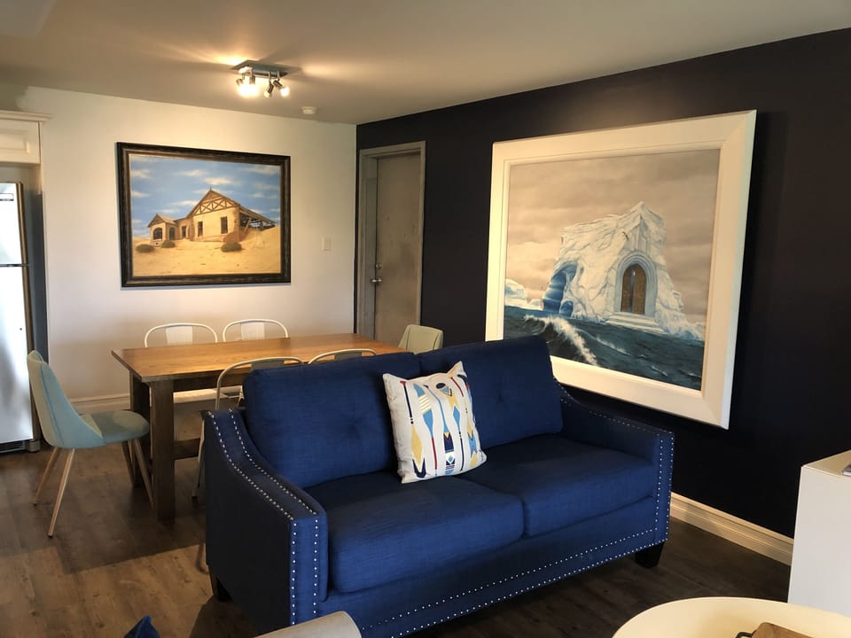 Open concept dining area with original South African paintings. 