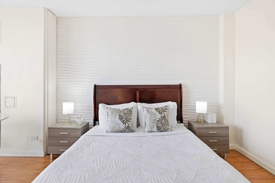 Cozy bed with tropical accents and elegant lighting
