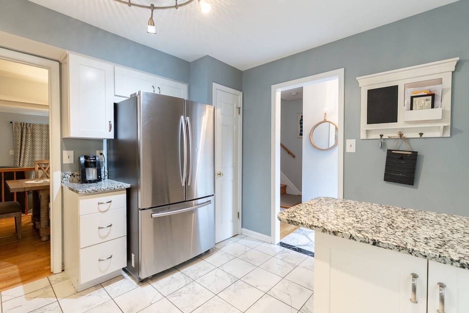 The gourmet kitchen has stainless steel appliances, a coffee pot, toaster and microwave.